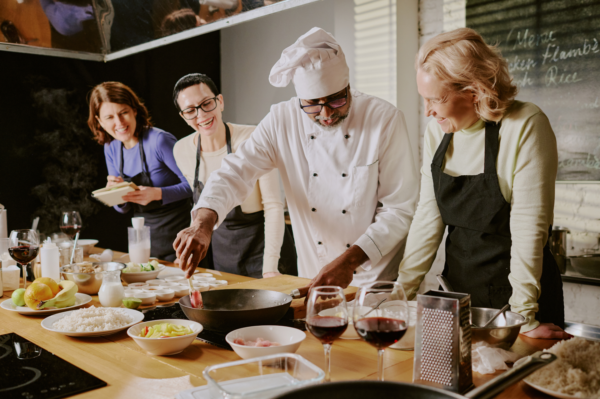 Members laughing during a chef-led cooking class